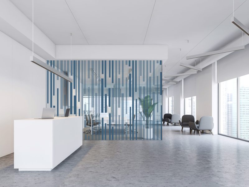 Interior of modern office with white walls, concrete floor, white reception table, meeting room with glass walls and lounge with armchairs. 3d rendering