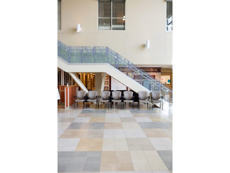 Empty chairs and staircase in hospital lobby