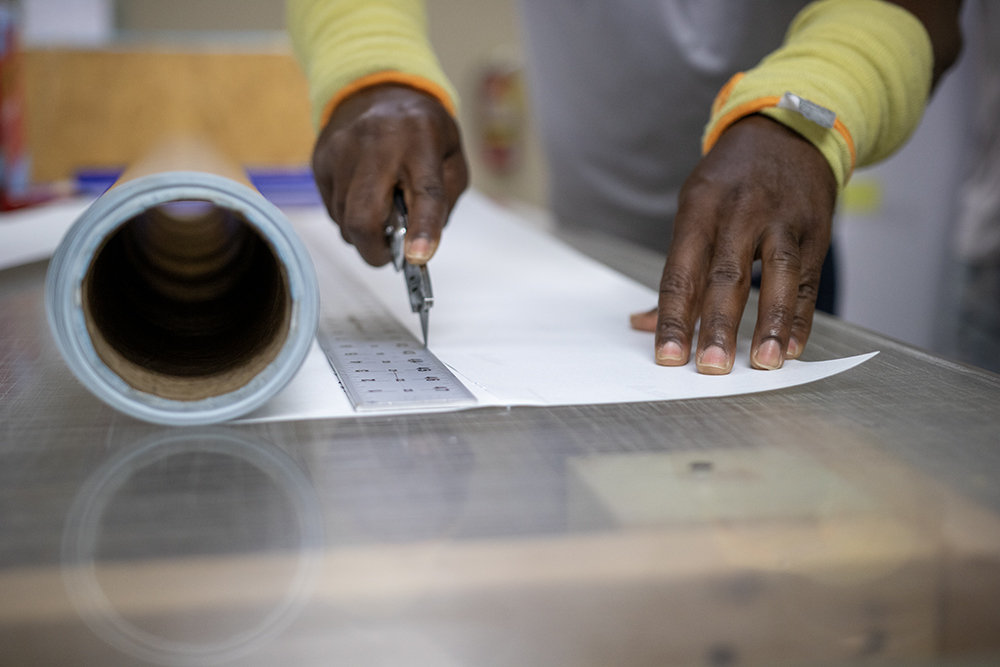 Privacy Glass Solutions team member precisely preparing material at the Coral Springs facility