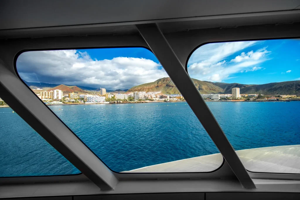 Coastal city and ocean viewed through large framed marine windows