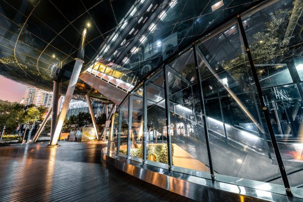 Contemporary architectural glass façade with curved glazing and complex structural details